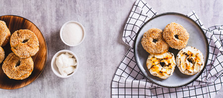 Sweet creme brulee bagels with cream cheese and caramelized sugar for breakfast top view web bannerの写真素材