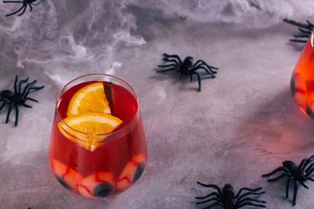 Halloween fruit blood cocktail with eyes and orange in glassesの写真素材