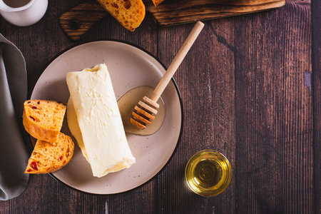 Turkish creamy dairy kaymak, honey and bread on a breakfast plate top viewの写真素材