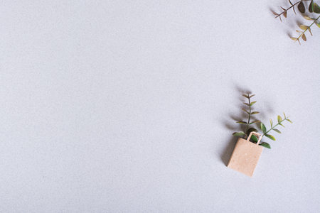 Green Friday paper craft bag with branches on a green background top view copy spaceの写真素材