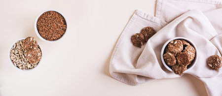 Homemade crispbread made from flax and sunflower seeds in a bowl on the table top view web bannerの写真素材
