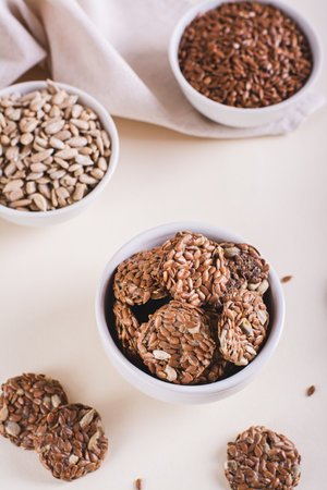 Homemade crispbread made from flax and sunflower seeds in a bowl on the table vertical viewの写真素材