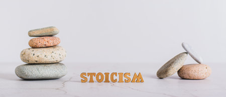 Concept stoicism word made from letters and pyramid of stones on gray background web bannerの写真素材