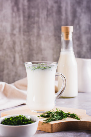 Ayran homemade yogurt drink with dill in a glass on the table vertical viewの写真素材