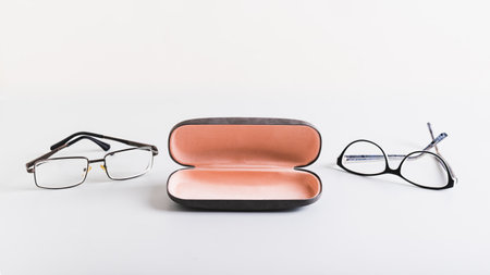 Open hard storage case and eyeglasses nearby on the table web banner