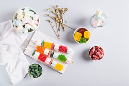Gummy candy kabobs on skewers served on the table top viewの写真素材