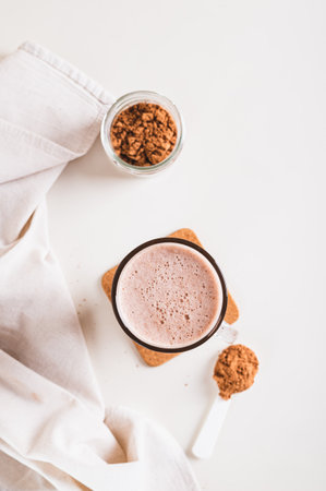 Chocolate protein energy shake drink in a glass on the table top and vertical viewの写真素材