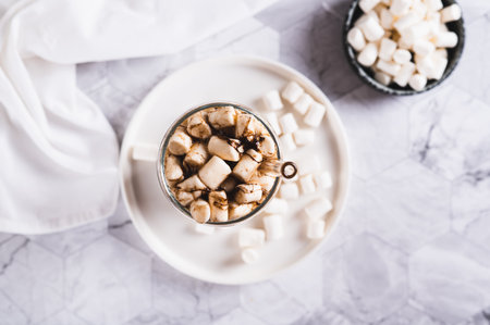 Trendy drink of cola and marshmallow in a glass on the table top viewの写真素材
