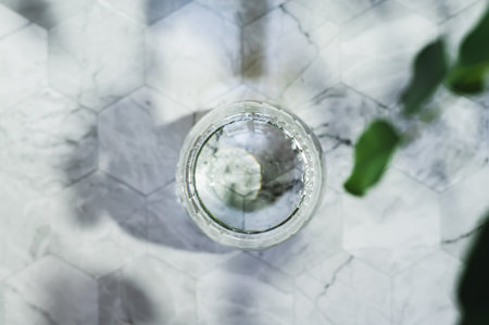 Close up of clean organic water in glasses on table against background in shadows top viewの写真素材