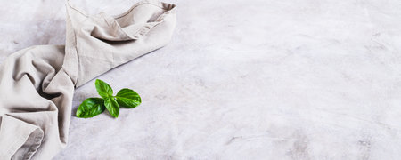 Fresh basil leaves and fabric on gray background web bannerの写真素材