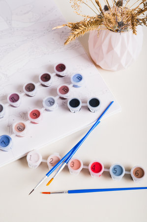 Home painting kit for painting by numbers on the table vertical viewの写真素材
