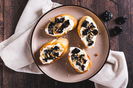 Close up of delicious toasts with ricotta and prunes on a plate on the table web banner top viewの写真素材