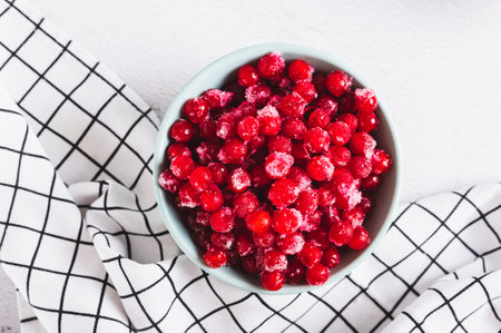 Frozen viburnum in a bowl on the table top view