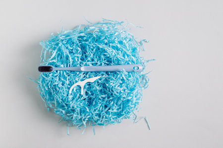 Toothbrush and disposable toothbrush on gift wrap filler top viewの写真素材