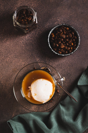 Affogato espresso coffee with vanilla ice cream in a cup on the table top and vertical view