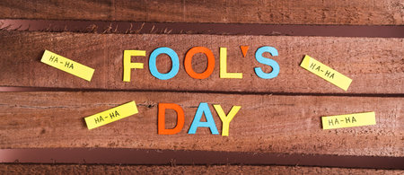 April Fools Day from colored letters, funny notes and paper on wooden top view web bannerの写真素材