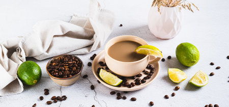 Cold coffee with lime wedges in a cup on the table web bannerの写真素材