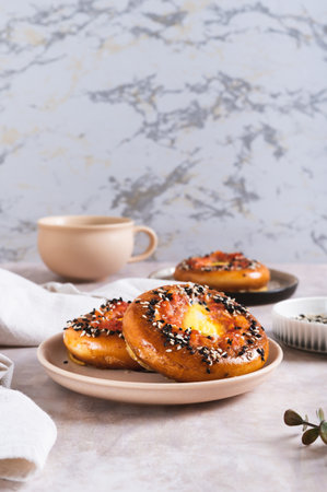 Baked bagels with tomato and quail egg on a plate on the table vertical viewの写真素材
