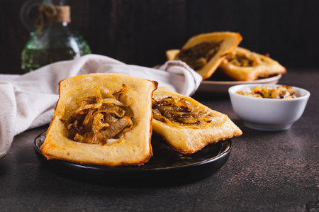 Upside down tarts with caramelized onions on a plate on a tableの写真素材