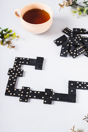 Traditional black dotted dominoes for table game vertical view