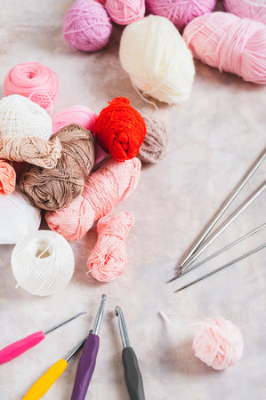 Yarn and tools for a cozy home knitting hobby on the table vertical viewの写真素材