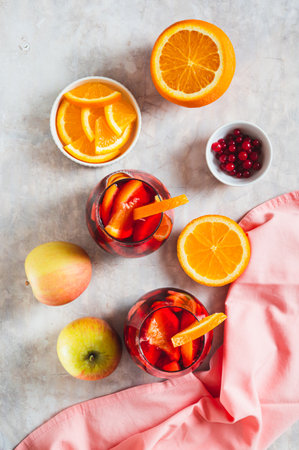 Sangria cocktail with red wine and fruits in glasses on table top and vertical viewの写真素材