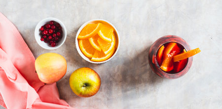 Sangria cocktail with red wine and fruits in glasses on table top view web banner