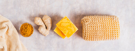 Herbal turmeric soap bars and root on the table top view web bannerの写真素材
