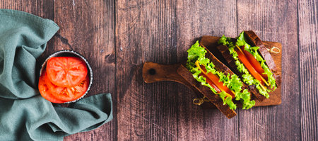 Light sandwich with vegetables and cheese on rye bread on a board top view web bannerの写真素材