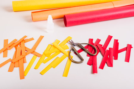 Strips of colored paper, scissors and glue to make paper garlands