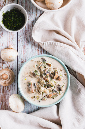 Cheesy stewed mushroom sauce in a bowl on the table top and vertical viewの写真素材