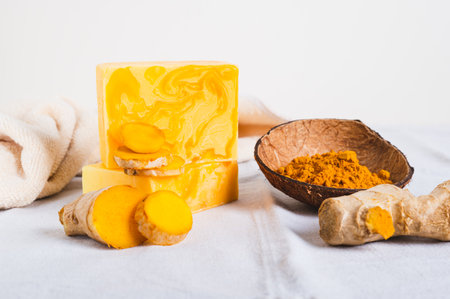 Natural homemade rejuvenating soap with turmeric on the tableの写真素材