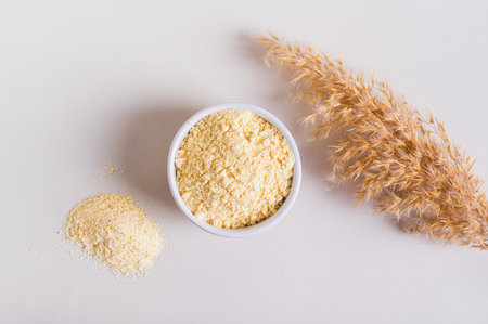 Close up of peptide powder in a bowl and a glass of water on the table top view