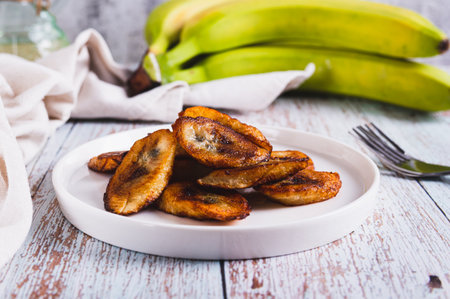 Fried plantain banana slices on a plate on the tableの写真素材