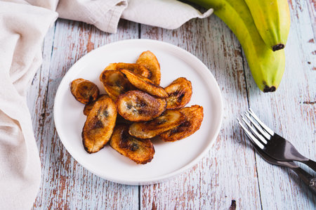 Tajadas fried banana on a plate on the tableの写真素材