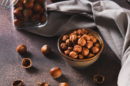 Nourishing hazelnuts without shells in a bowl for diet on the tableの写真素材