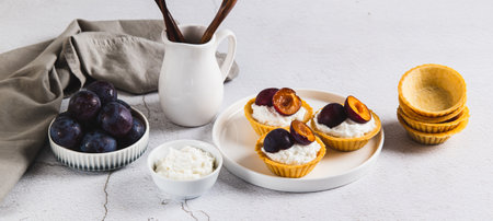 Mini pastries with cottage cheese and berries on a plate on the table web banner