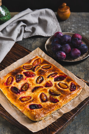 Sweet homemade focaccia with berries on paper on the table vertical viewの写真素材