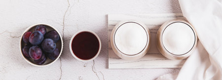 Coffee latte with berry syrup in glasses on the table top view web bannerの写真素材