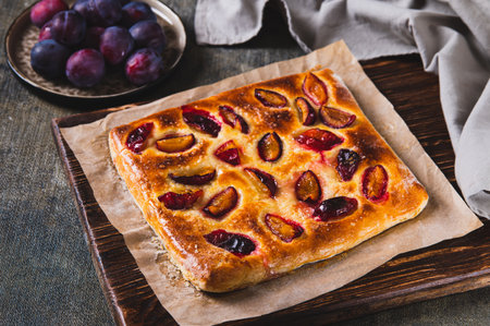 Sweet homemade focaccia with berries on paper on the tableの写真素材