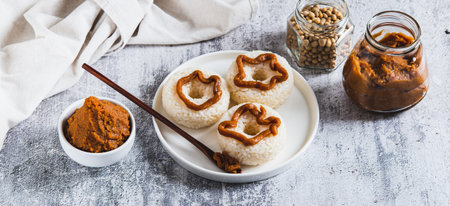 Spicy rice donuts with miso paste on a plate on the table web banner