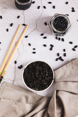 Asian fermented black beans on a plate on the table top and vertical viewの写真素材