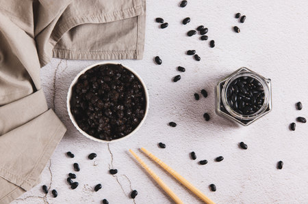 Fermented black douchi beans in a bowl on the table top viewの写真素材