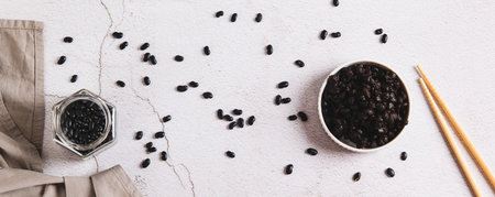 Asian fermented black beans on a plate on the table top view web bannerの写真素材