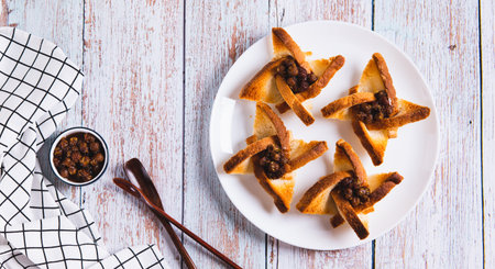 Baked creative toasts with berry jam on a plate on the table top view web banner
