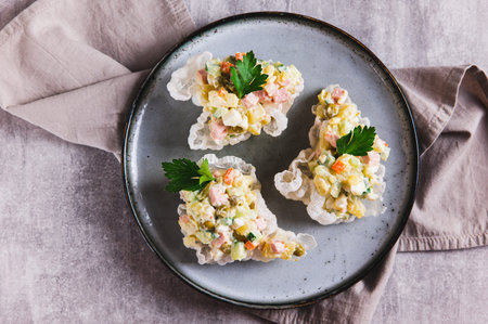 Close up of portioned Olivier salad creatively served on a plate on the table top viewの写真素材