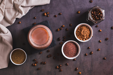 Spicy coffee with chocolate, salt and pepper in a glass on the table top viewの写真素材