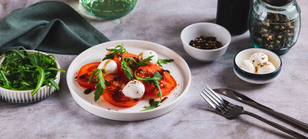 Mediterranean caprese salad with arugula on a plate on the table web bannerの写真素材