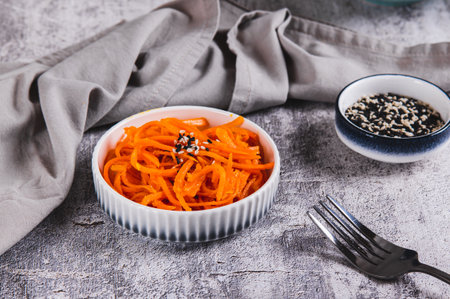 Marinated Korean carrot salad on a plate on the tableの写真素材
