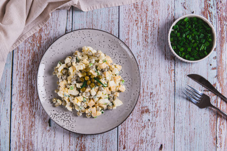 Protein salad with eggs, green peas and onions on a plate on the table top viewの写真素材
